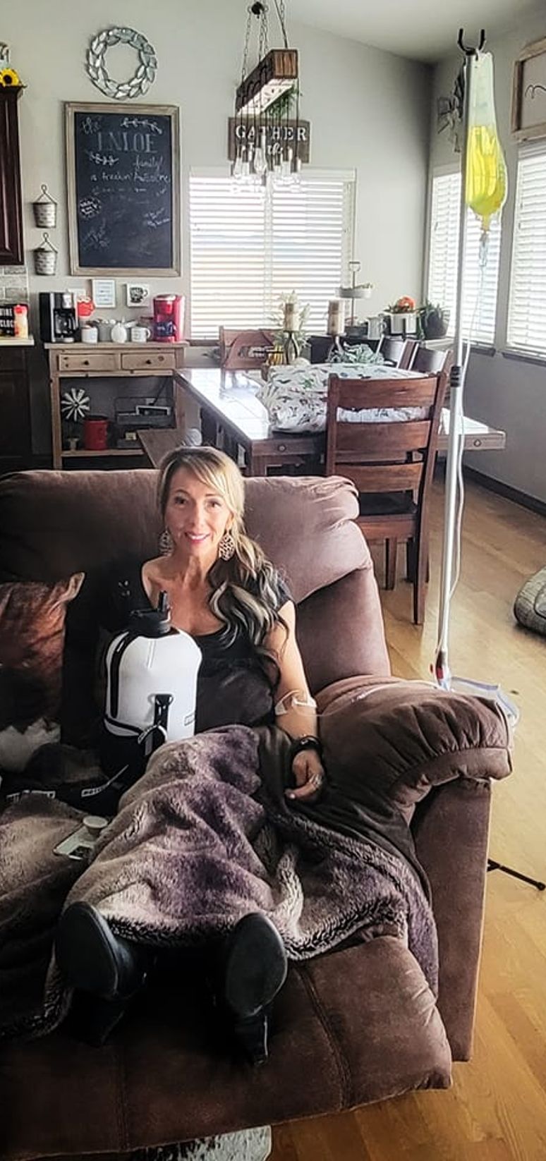 woman on couch getting iv therapy