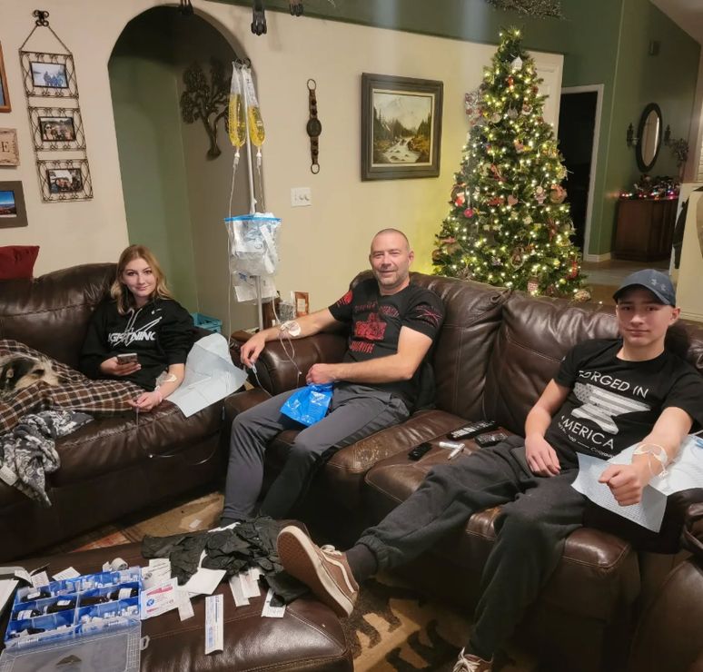 family on couch getting iv therapy